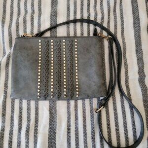 Gray crossbody bag with pink bow inside